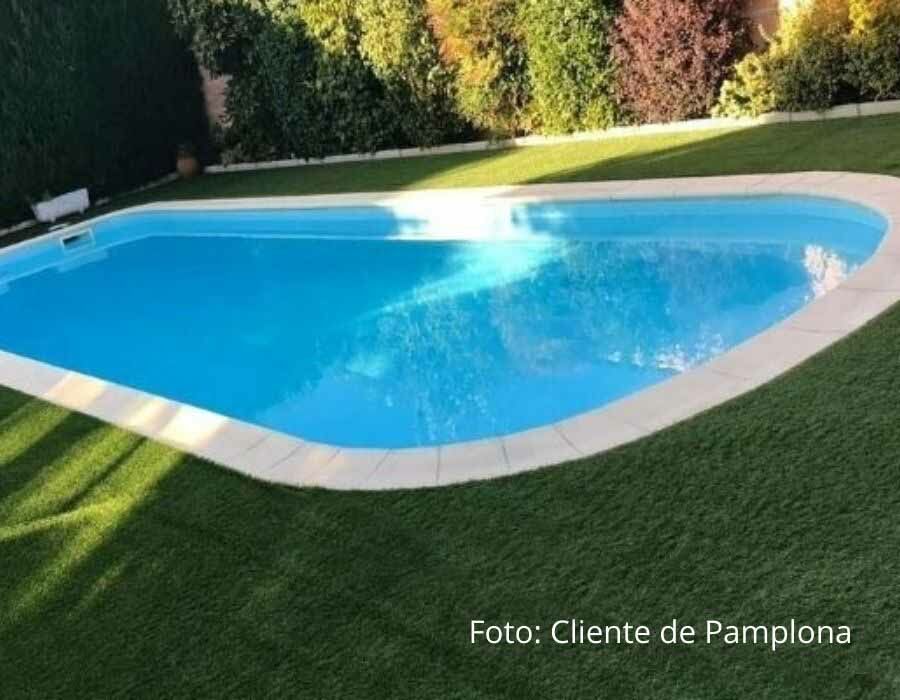 Jardín con piscina y césped artificial que no necesita riego ni siega